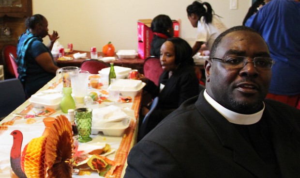 Pastor Wilkerson seated at table in church's backroom.